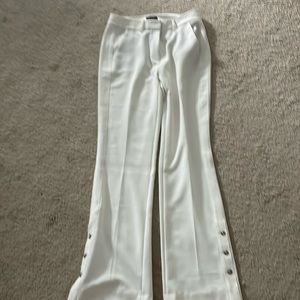 The limited ivory flare pants with button detail